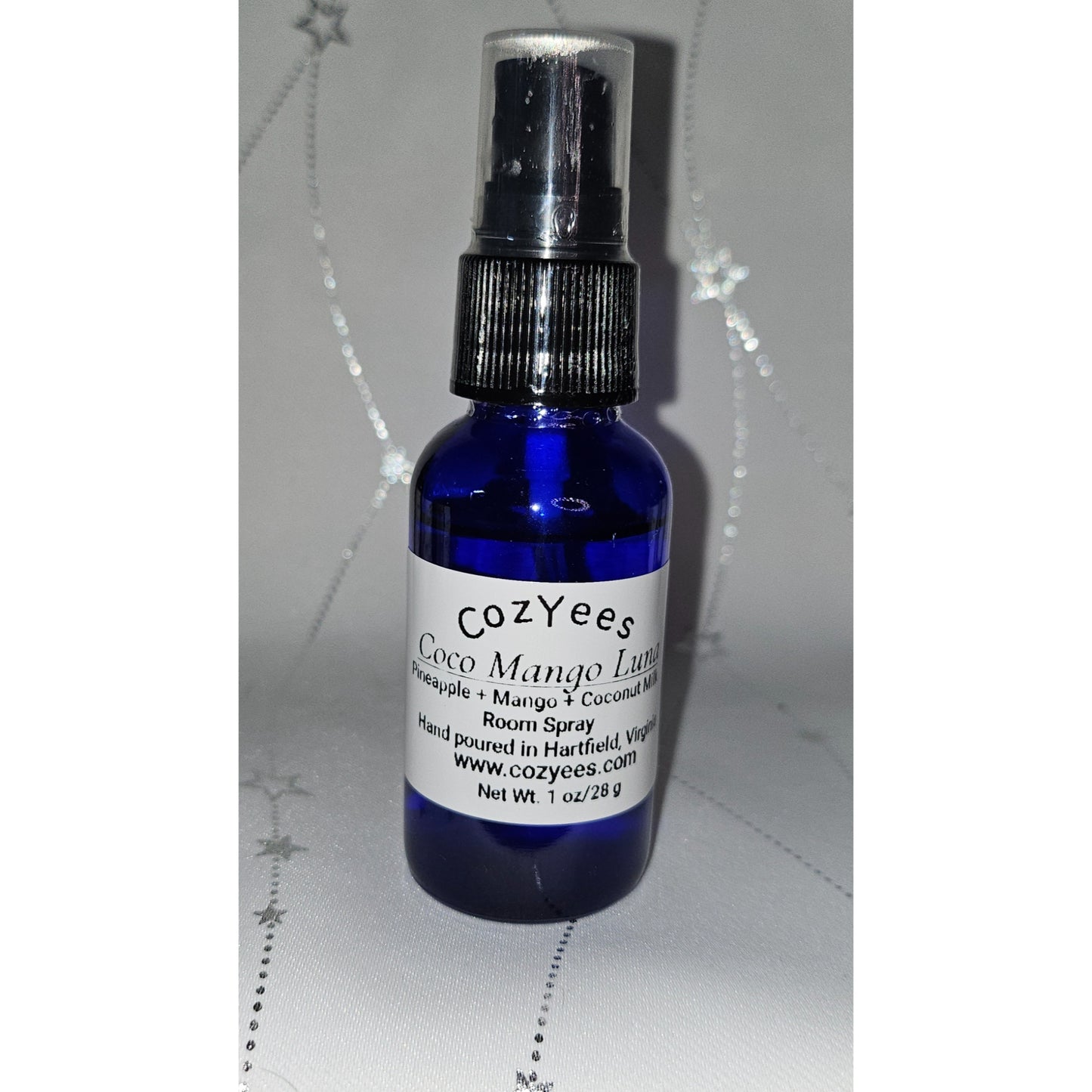 Blue spray bottle labeled 'Cozyees' on a white background