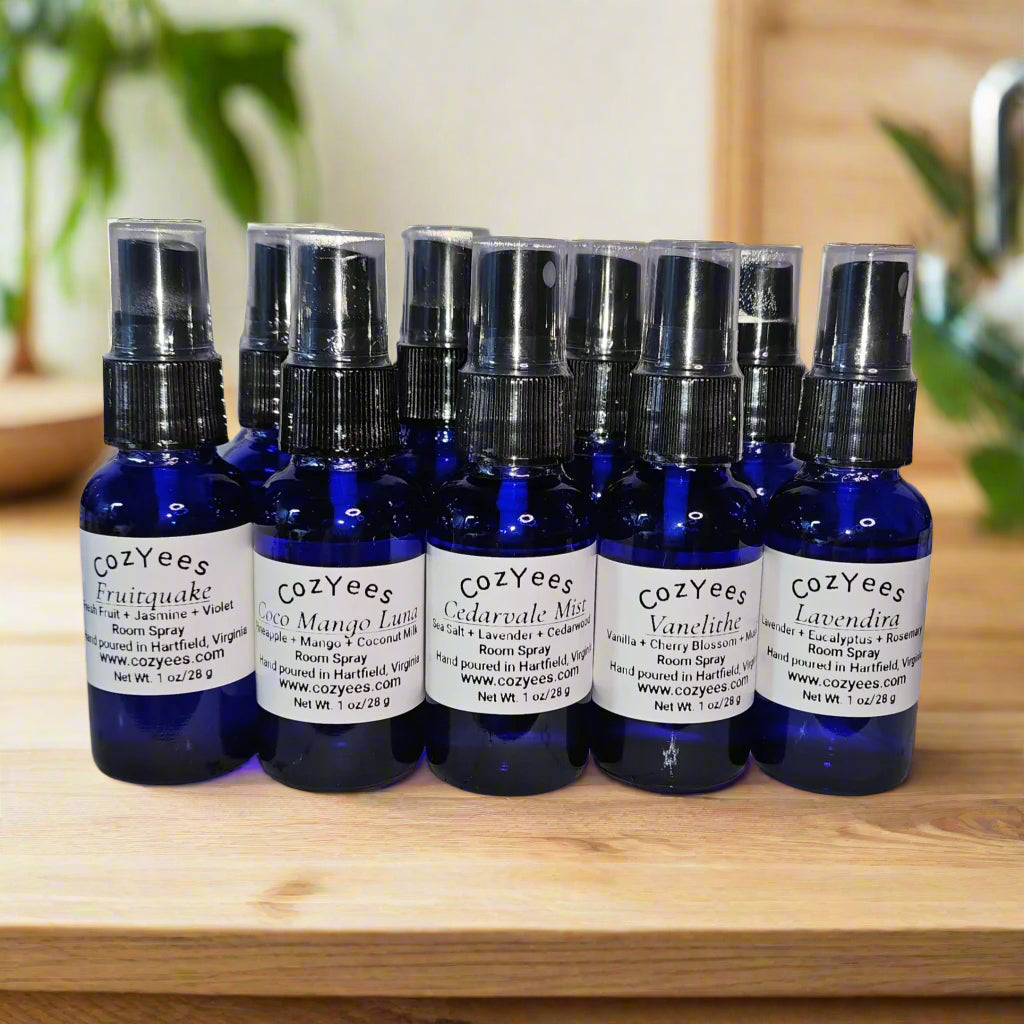Set of CozyYees room spray bottles on a wood tray