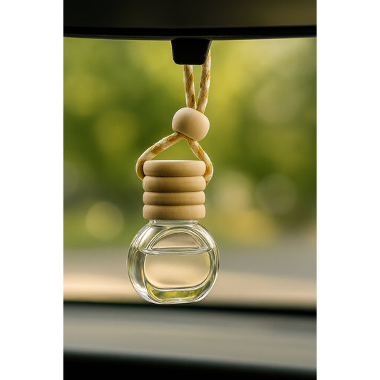 Cozyees car air freshener with wooden beads and clear glass holder hanging from a car's rearview mirror.