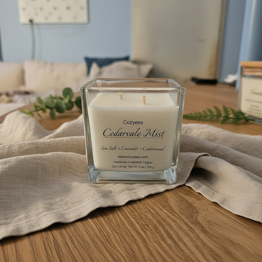 Cozyees-Cedarvale Mist candle in a clear square jar on wood table