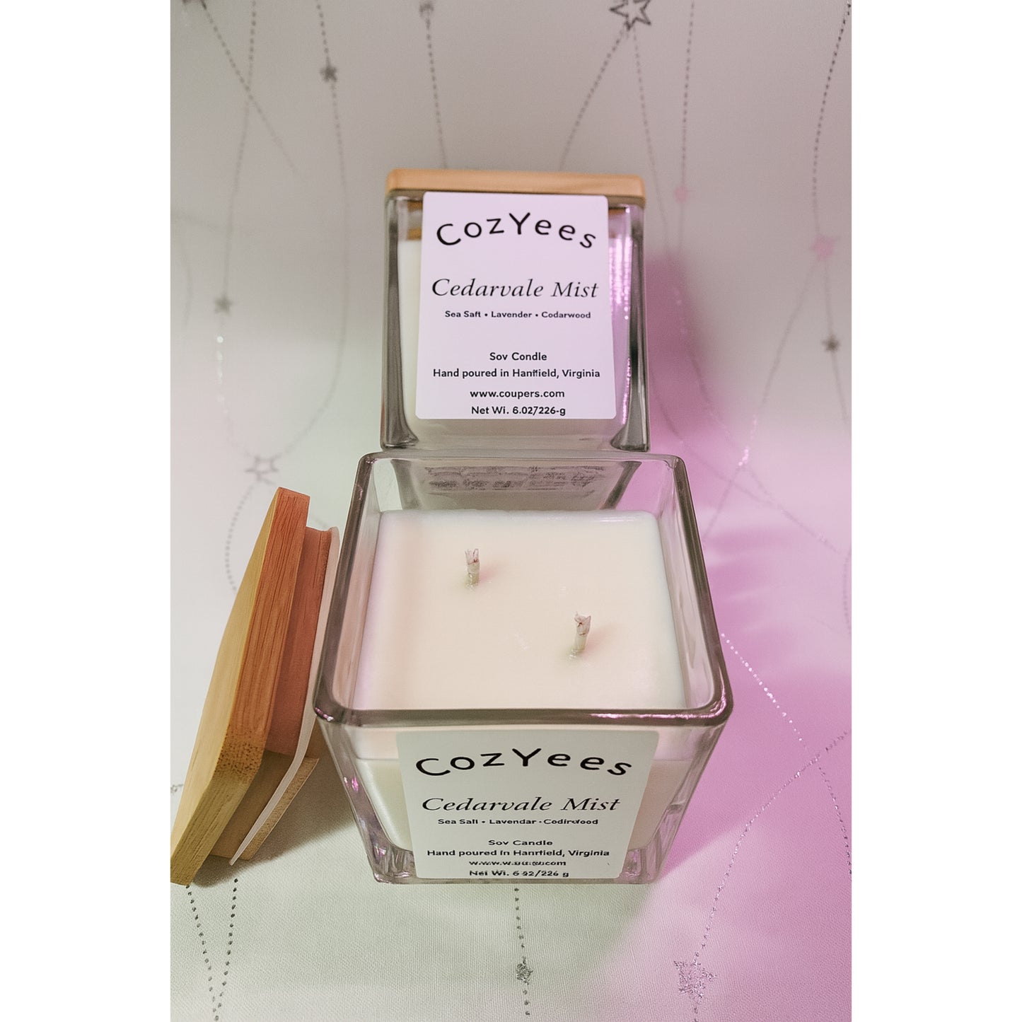 Cozyees Cedarvale Mist candle with wooden lid on a textured surface