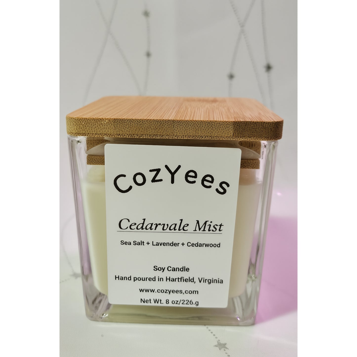 Cozyees Cedarvale Mist candle with a wooden lid on a white background