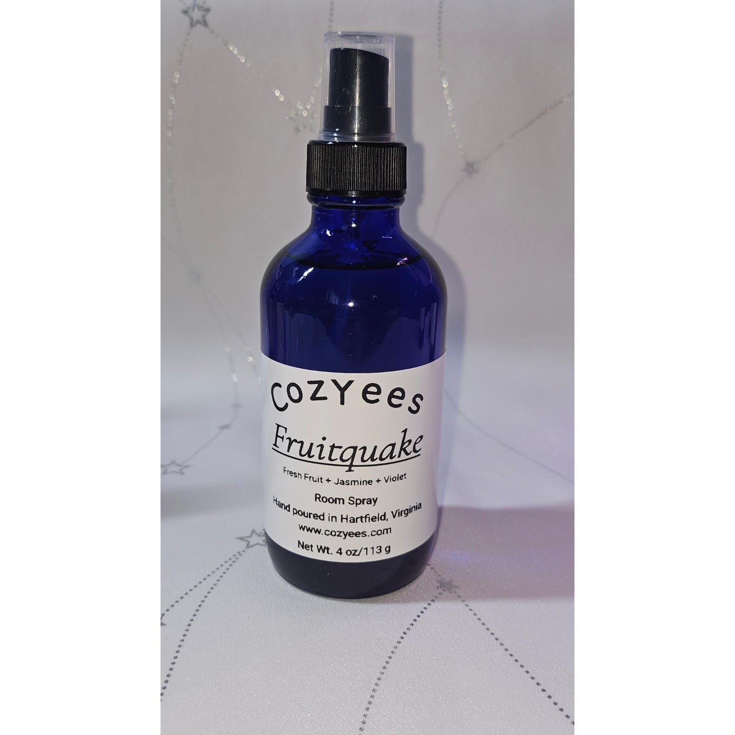 Blue spray bottle labeled 'Cozyees Fruitquake' on a white background