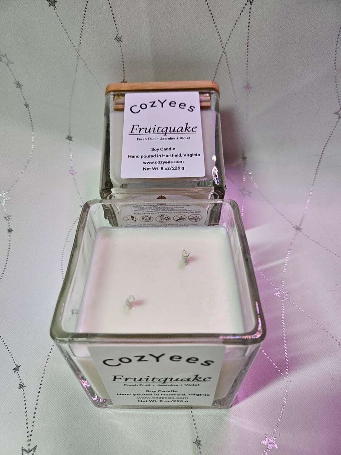 Overhead view of Fruitquake soy candle with double wick in a square jar