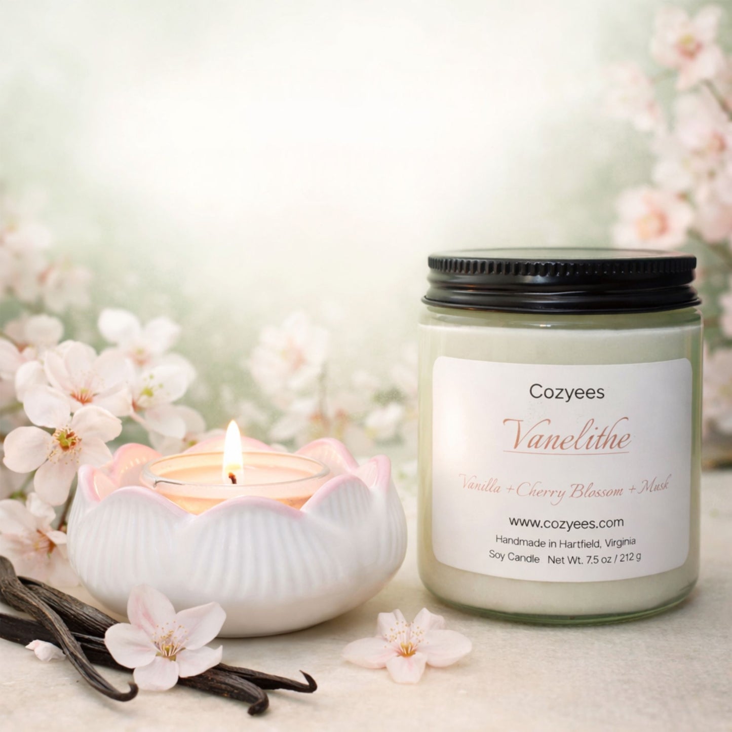 Cozyees Vanelithe candle with vanilla beans and flowers on a light background
