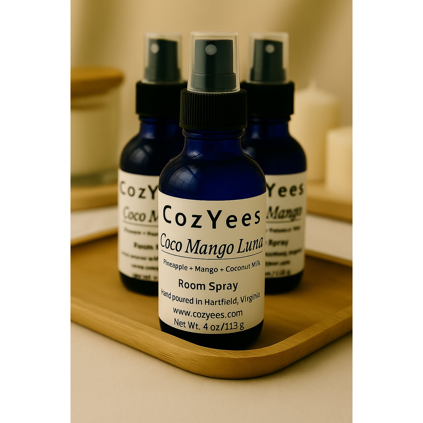 Cozyees Coco Mango Luma room spray bottles on a wooden tray.