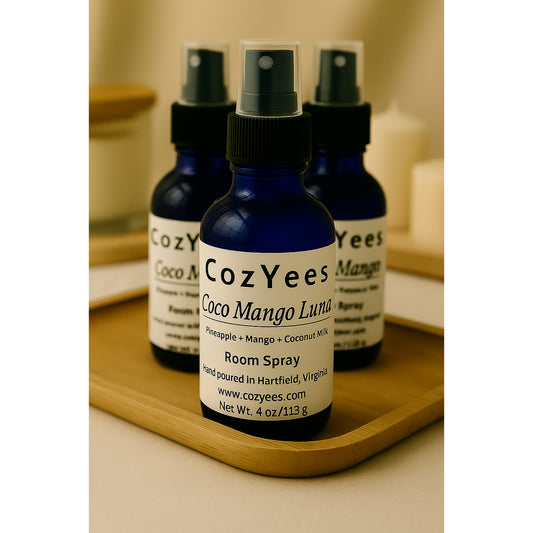 Cozyees Coco Mango Luma room spray bottles on a wooden tray.