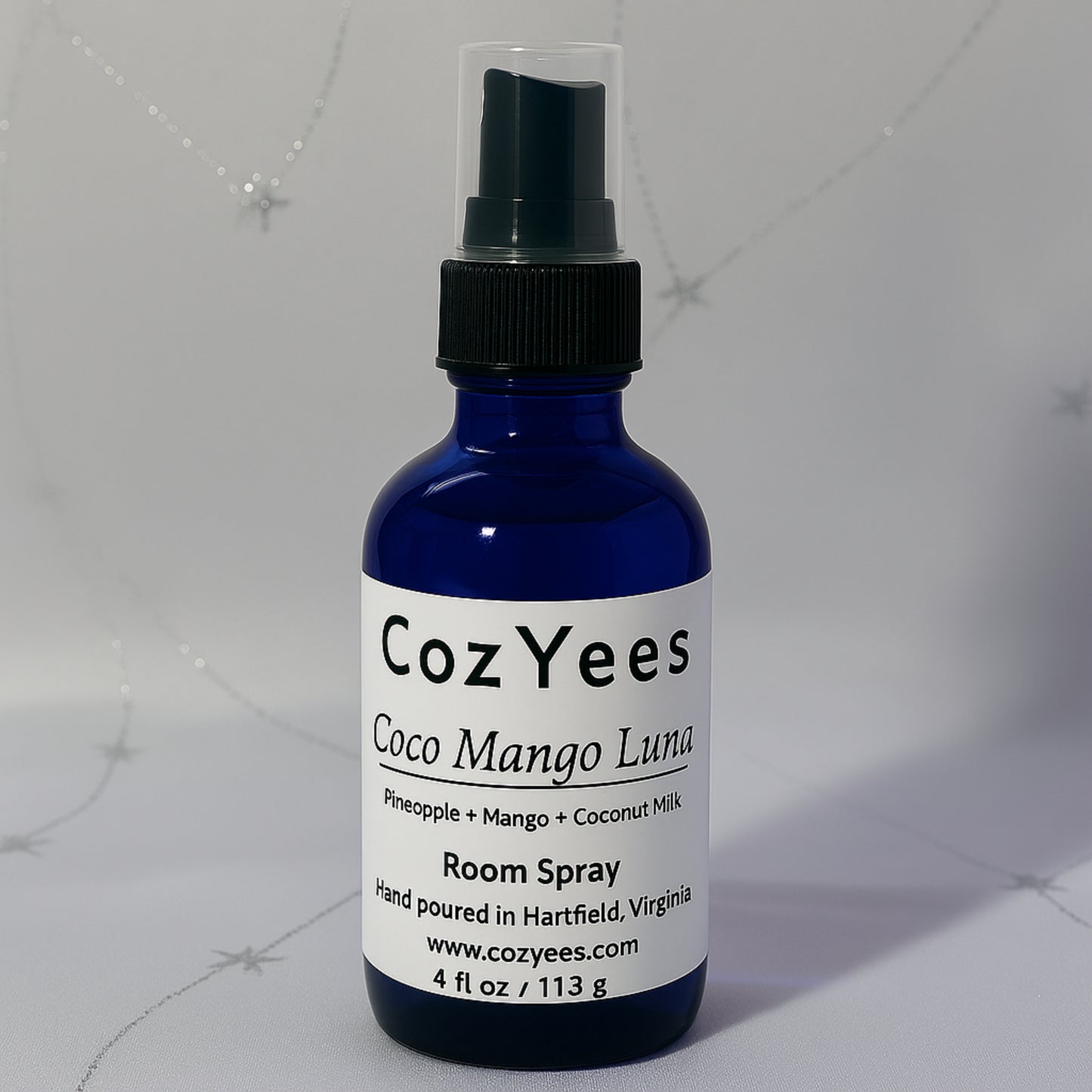 Cozyees Coco Mango Luna room spray bottle on a gray background