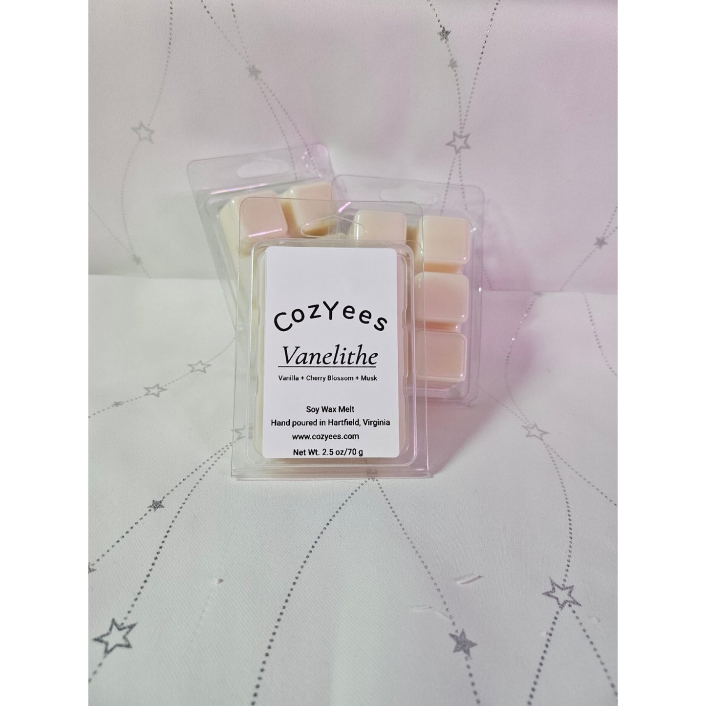 Packaged wax melts with 'cozyYees' branding on a textured surface