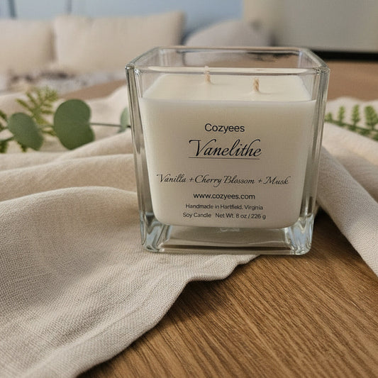 Cozyee Vanelithe candle in clear square jar on wood table