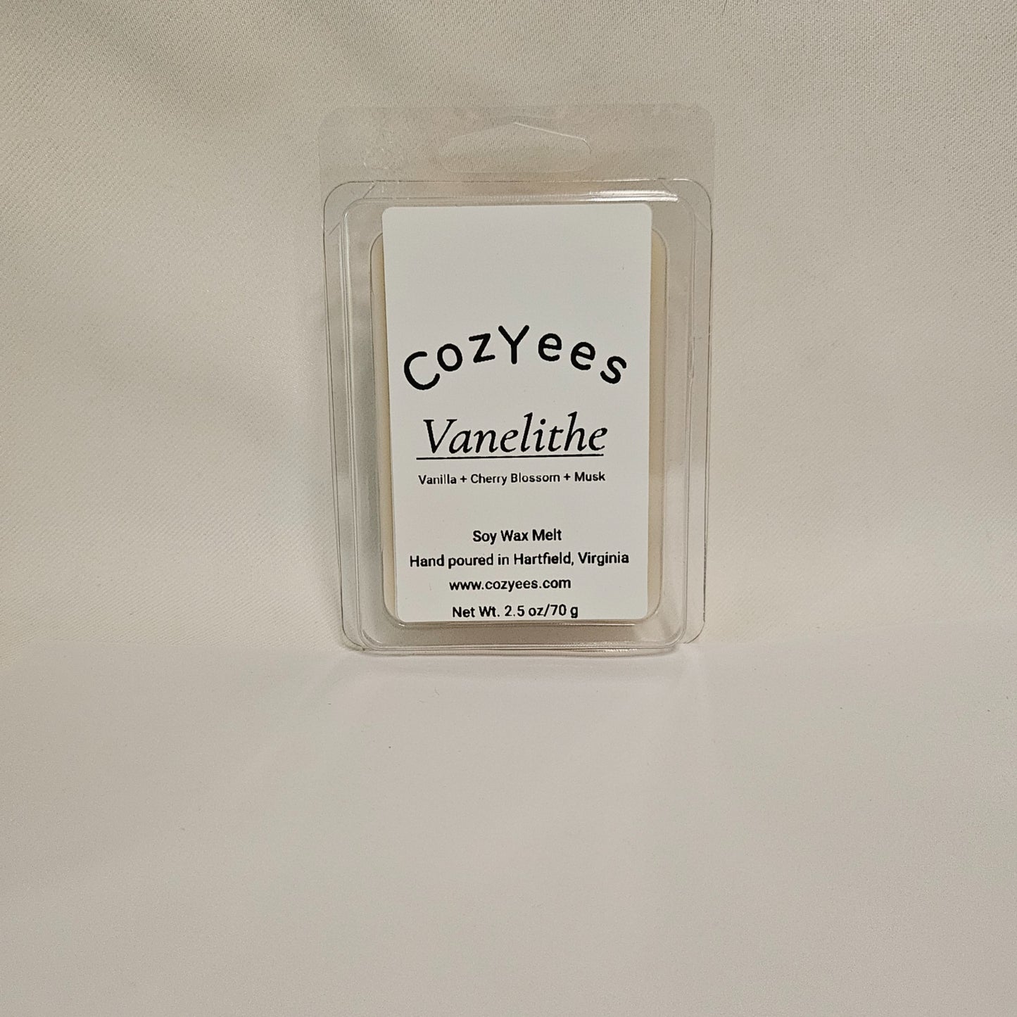Cozyees Vanelithe soy wax melt packaging on a beige background