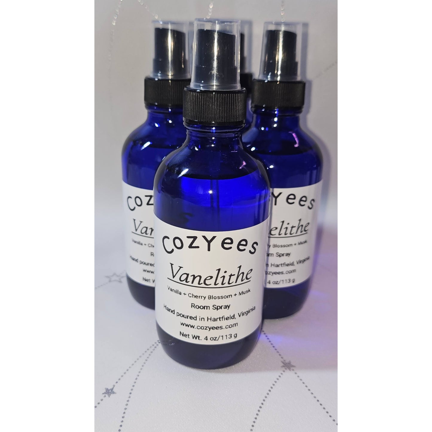 Three blue spray bottles labeled 'Cozyees Vanelithe' on a white background.
