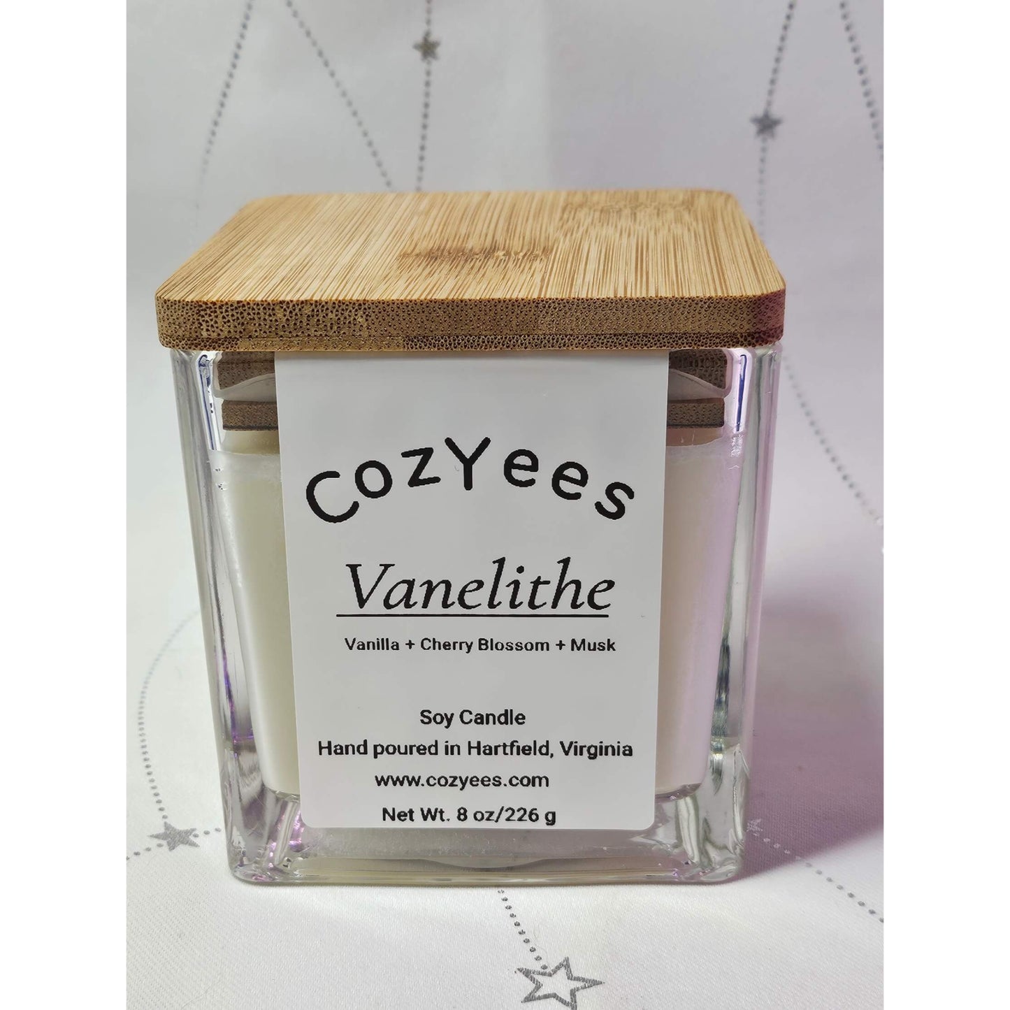 Cozyees Vanelithe candle with a wooden lid on a white background