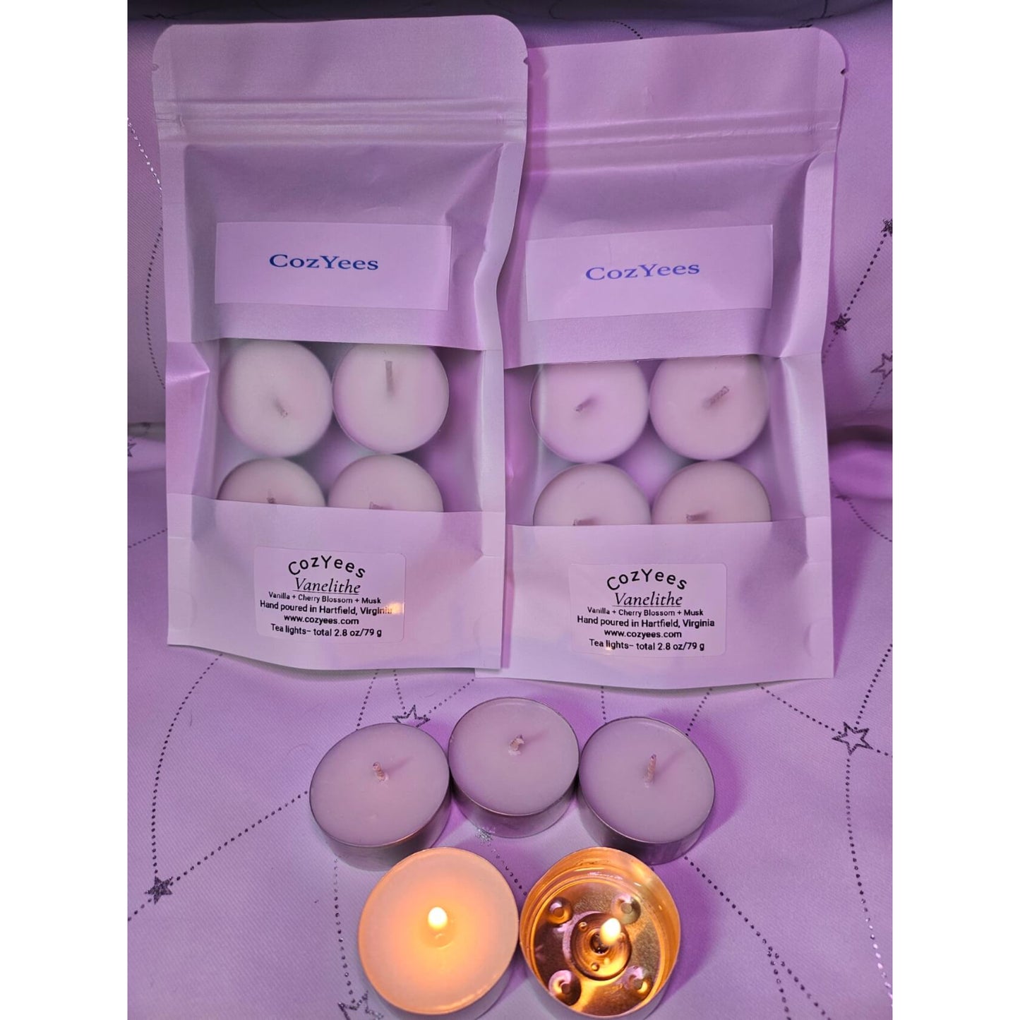 Cozyees candles in packaging on a matching purple background