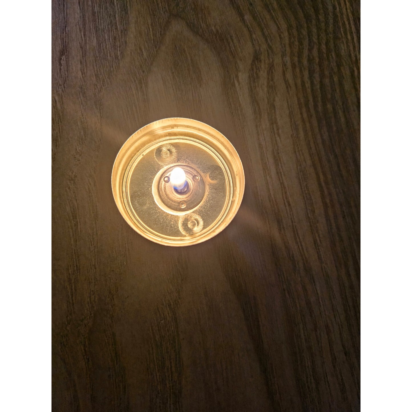lit tealight on a wooden surface