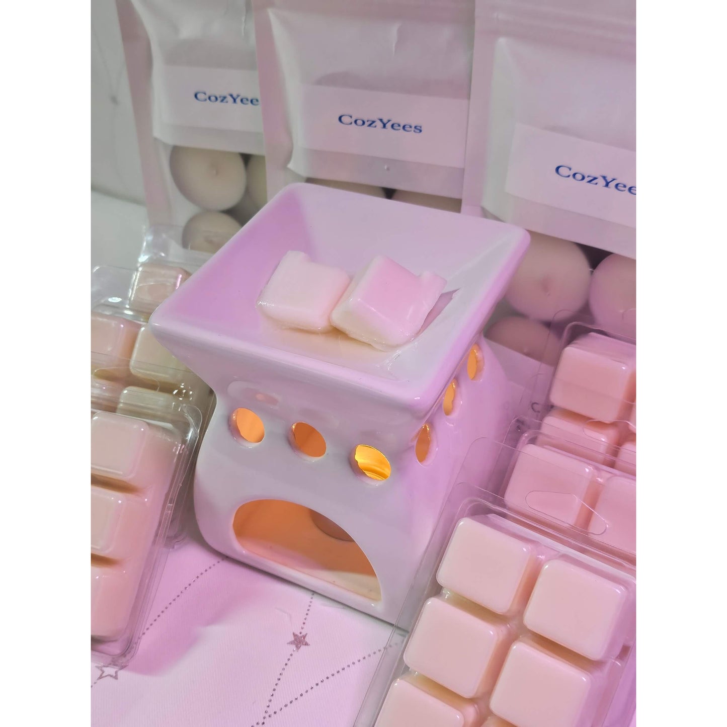 Pink wax warmer with Cozyee branding and pink wax cubes on a white background