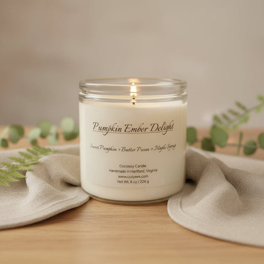 Cozyees Pumpkin Ember Delight CocoSoy candle burning in a clear glass jar for fall