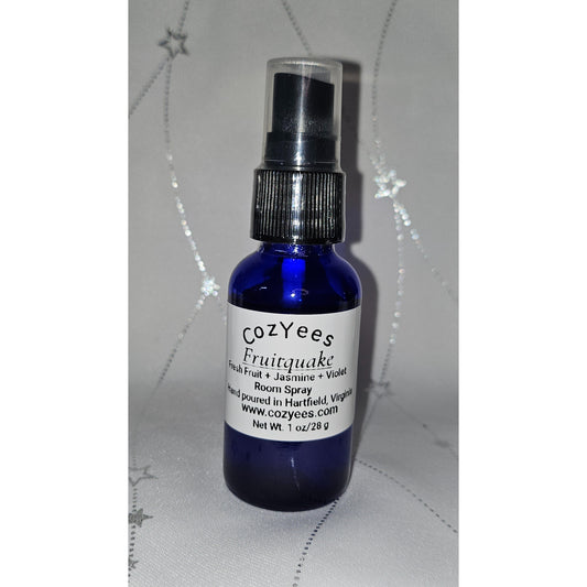 Blue spray bottle with a white label on a textured gray background