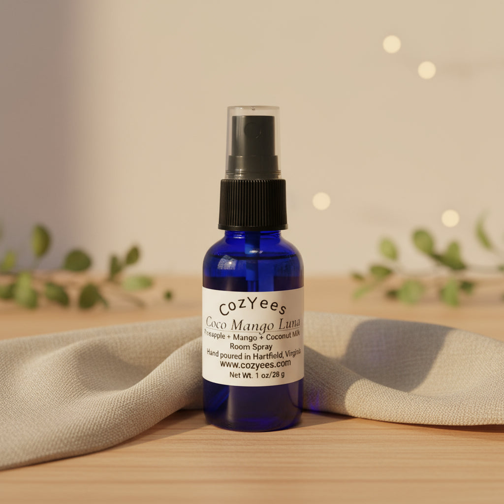 Blue spray bottle labeled 'cozyEes' on a wooden surface with a neutral background