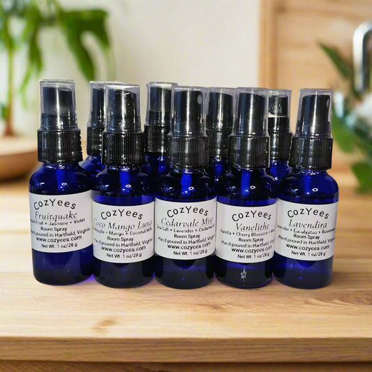 Set of CozyYees room spray bottles on a wood tray