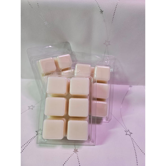 Pack of square wax melts in a clear plastic packaging on a textured white background