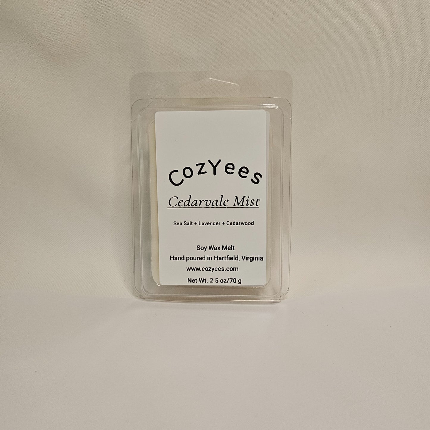 Cozyees Cedarvale Mist soy wax melt packaging on a beige background