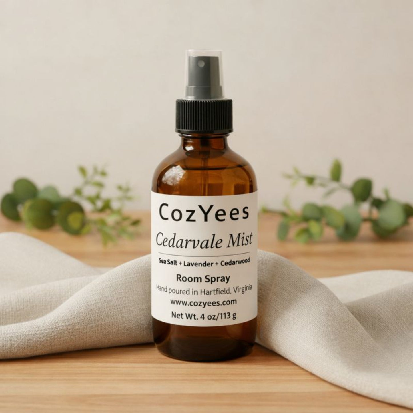 CozYees Cedarvale Mist room spray bottle on a wooden surface with a neutral background