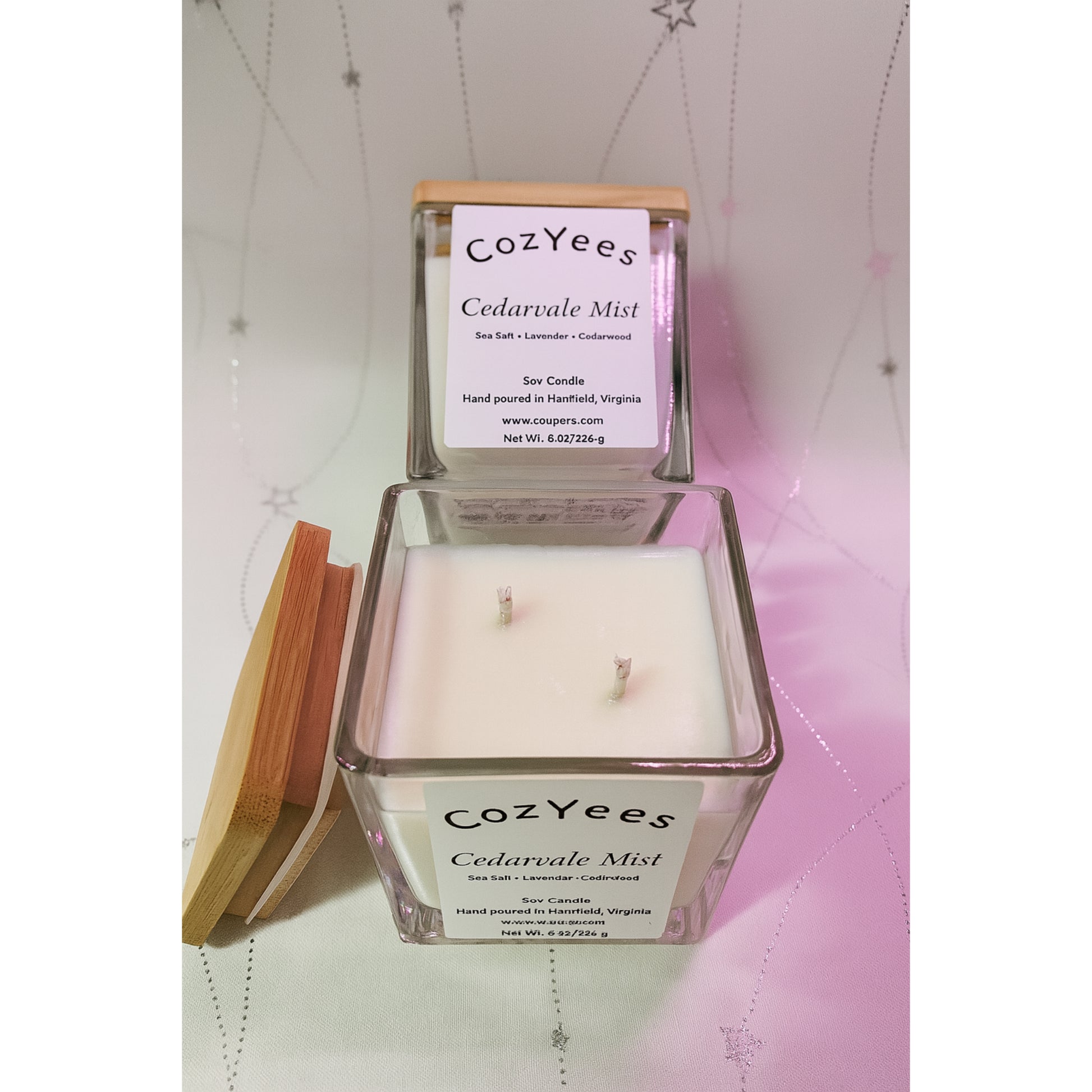 Cozyees Cedarvale Mist candle with wooden lid on a textured surface