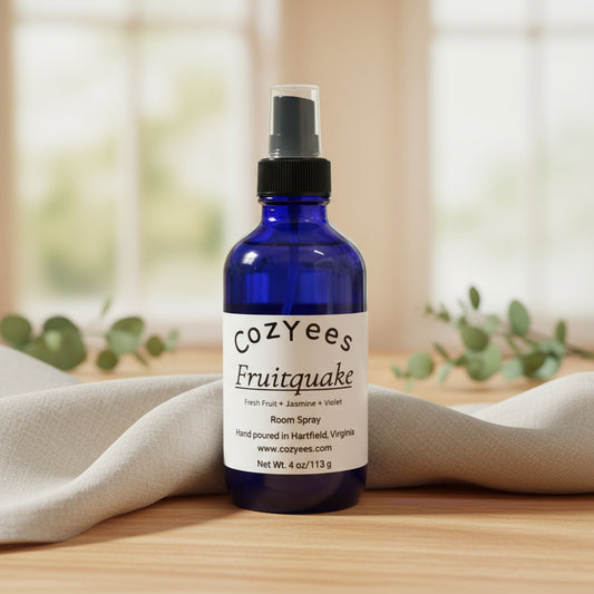 Blue spray bottle labeled 'Cozyees Fruitquake' on a white background