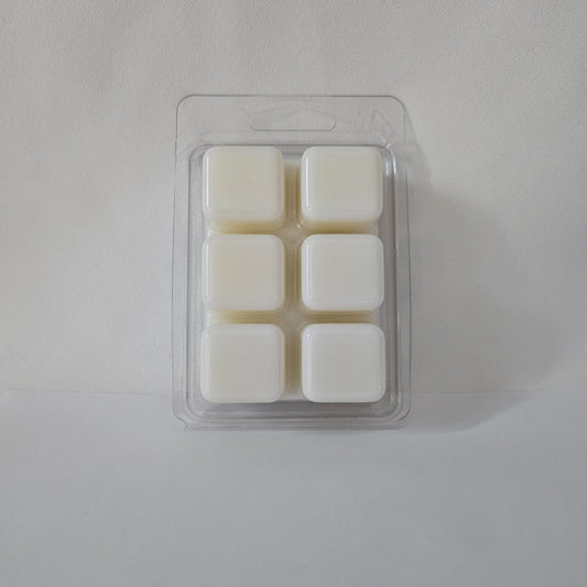 Pack of four white wax melts in a clear plastic packaging on a light gray background