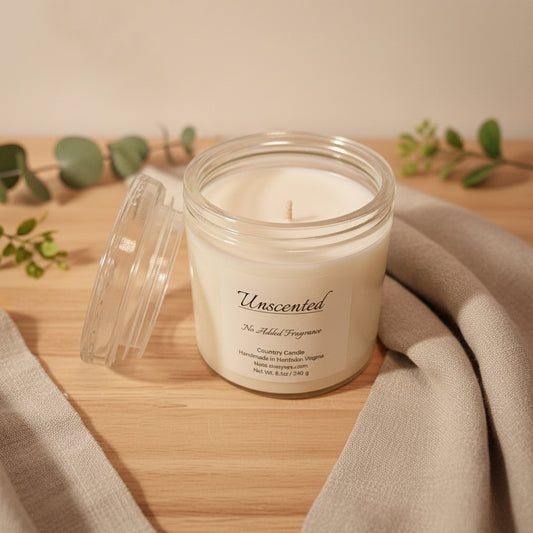Unscented candle in a glass jar with a label on a white background