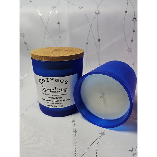 Blue candle with wooden lid on a white background
