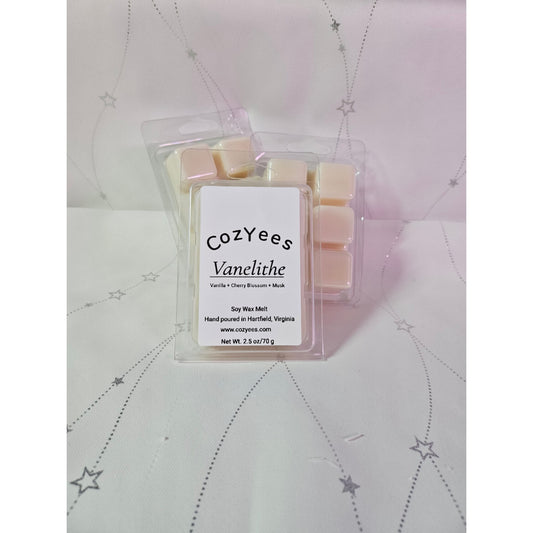 Packaged wax melts with 'cozyYees' branding on a textured surface