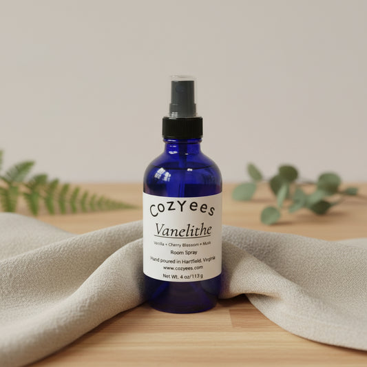 Blue spray bottle labeled 'Cozyees' on a white background