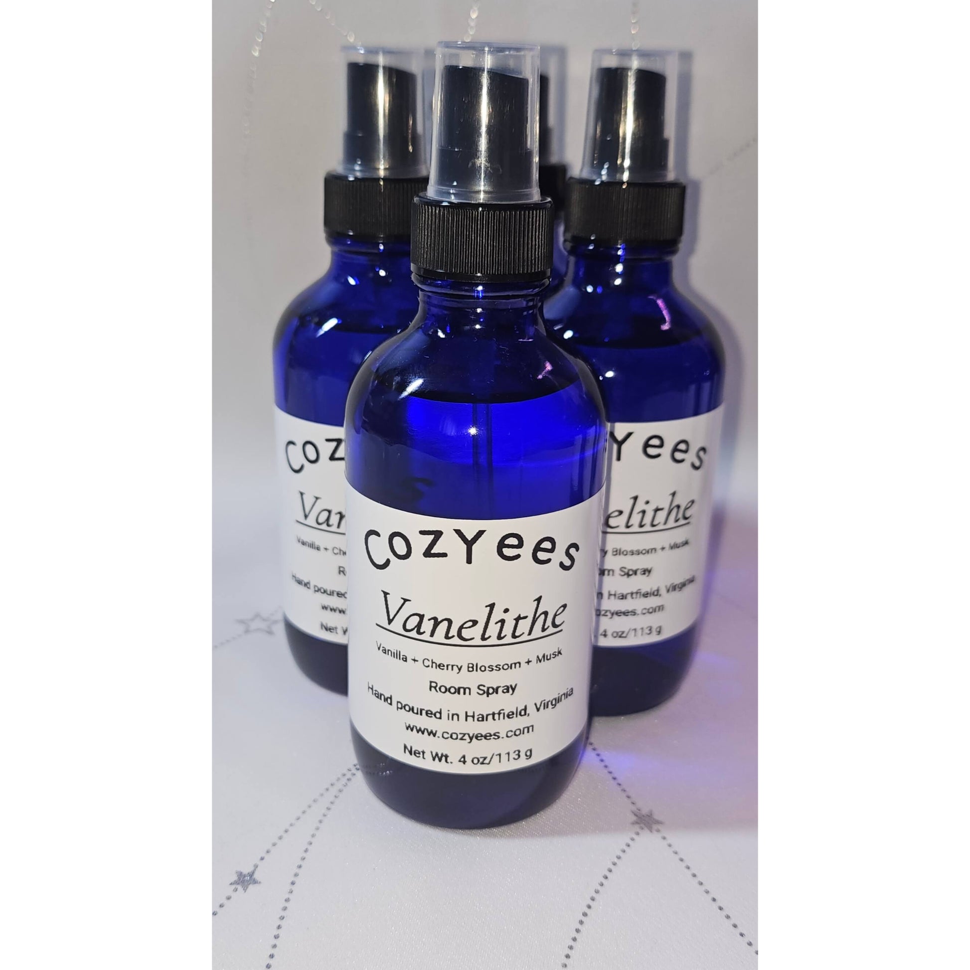 Three blue spray bottles labeled 'Cozyees Vanelithe' on a white background.