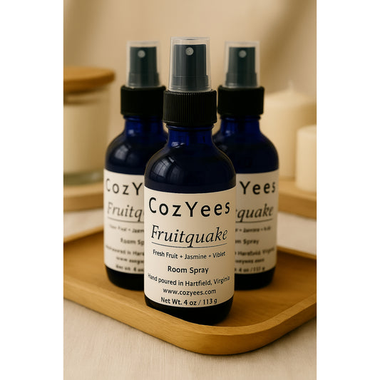 Three CozYees Fruitquake room spray bottles on a wooden tray.