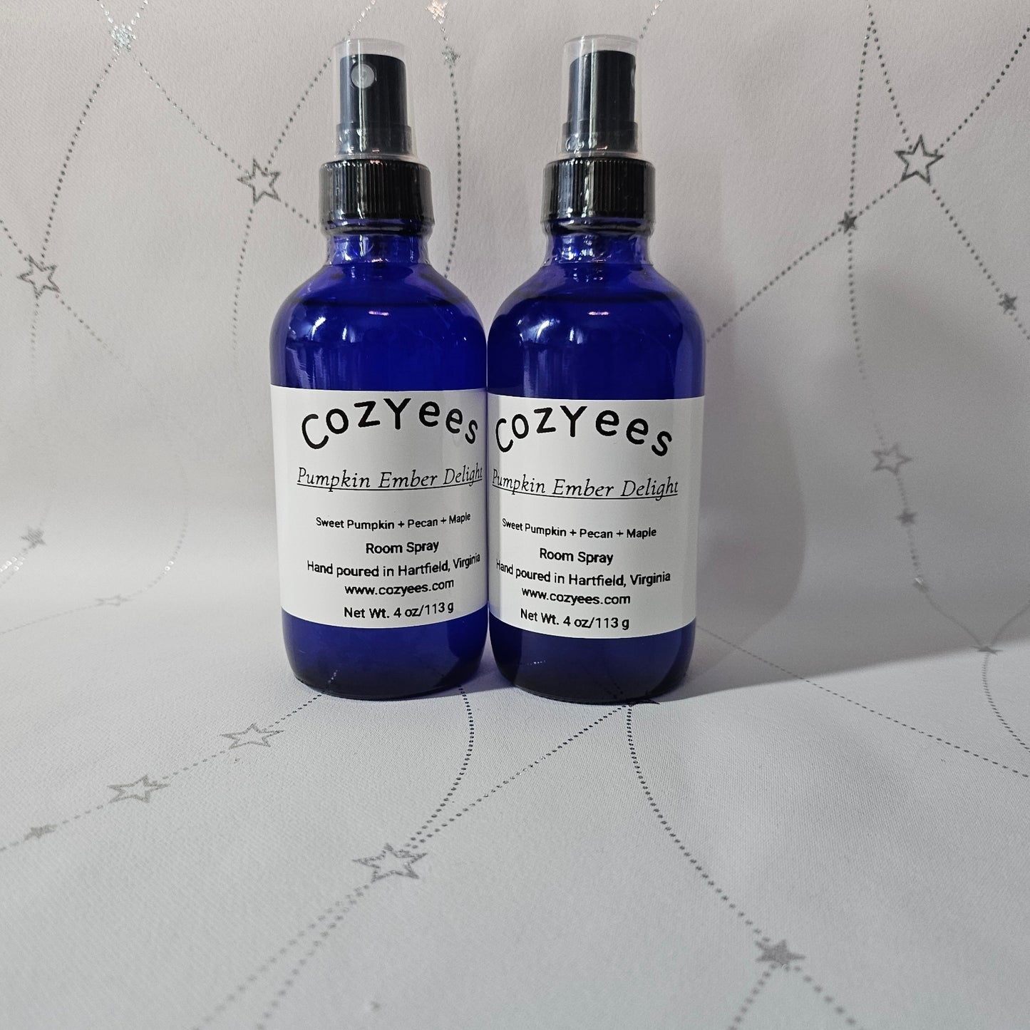 Two blue bottles with white labels on a gray textured background