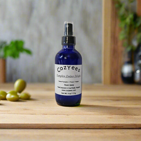 Blue Cozyees bottle on a textured white background