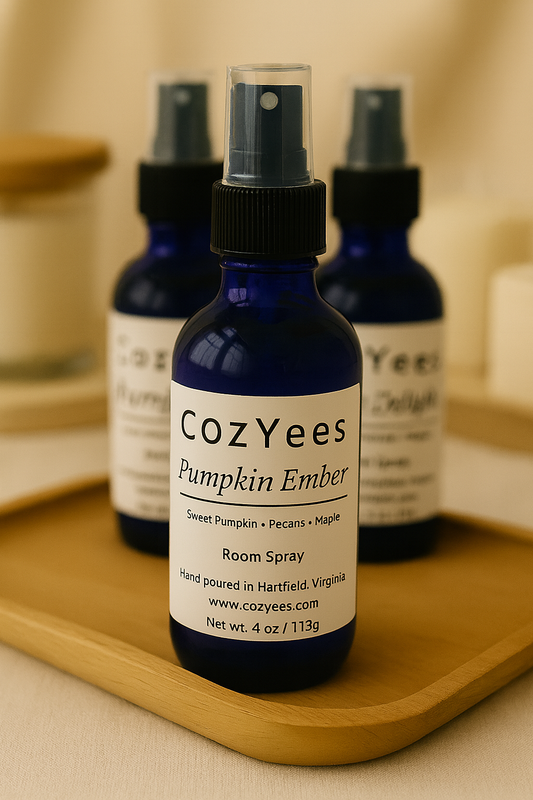 CozYees Pumpkin Ember room spray bottles on a wooden tray with a neutral background