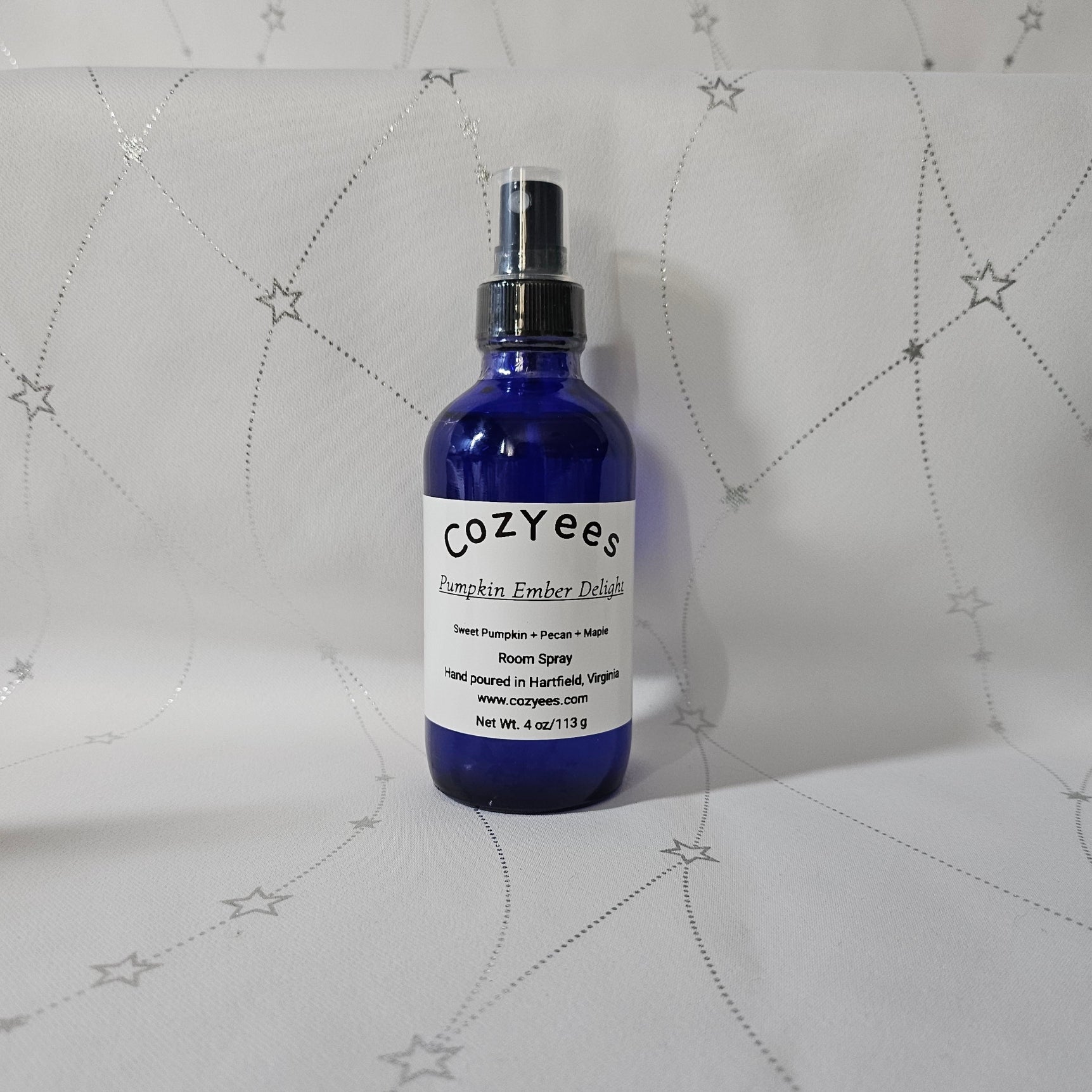 Blue Cozyees bottle on a textured white background
