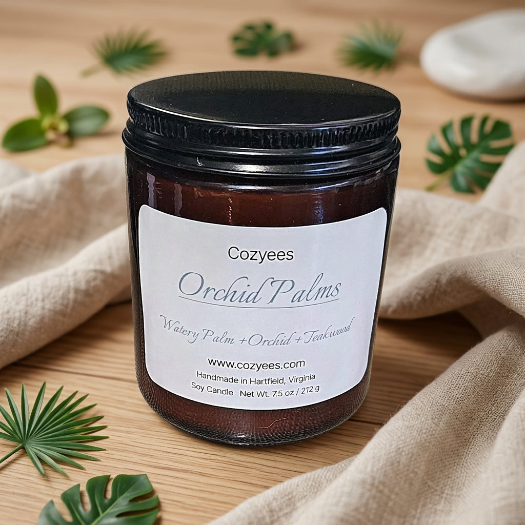 Cozyees Orchid Palms 7.5 oz soy candle in an amber glass jar with a black lid