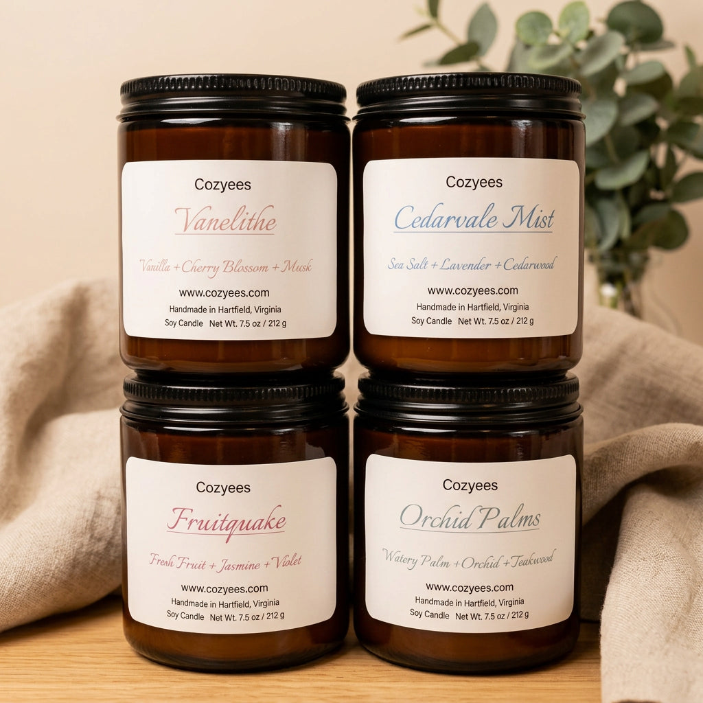 Four amber glass Cozyees soy candles stacked: Vanelithe, Cedarvale Mist, Fruitquake and Orchid Palms